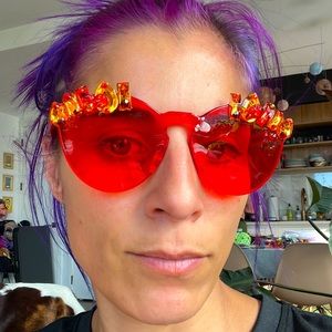 Round red sunglasses with orange gemstones and rhinestones